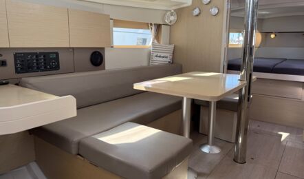 Salon der Segelyacht Oceanis 38.1 „Nature“ mit großem Salontisch und großzügigen Sitzgelegenheiten – Yachtcharter Ostsee