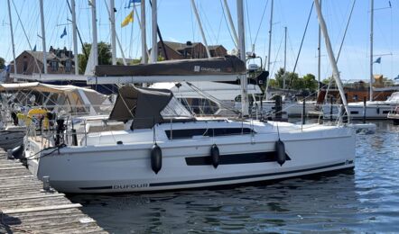 Steuerbordansicht der Segelyacht Dufour 37 „Chiquitita“ mit Sprayhood am Steg in Heiligenhafen – Yachtcharter Ostsee