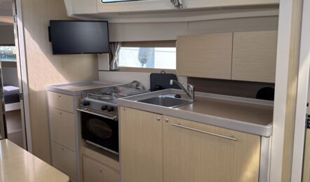 Offene Pantry der Segelyacht Oceanis 38.1 „Nature“ mit Gasherd, großem Kühlschrank und Fernseher – Yachtcharter Ostsee